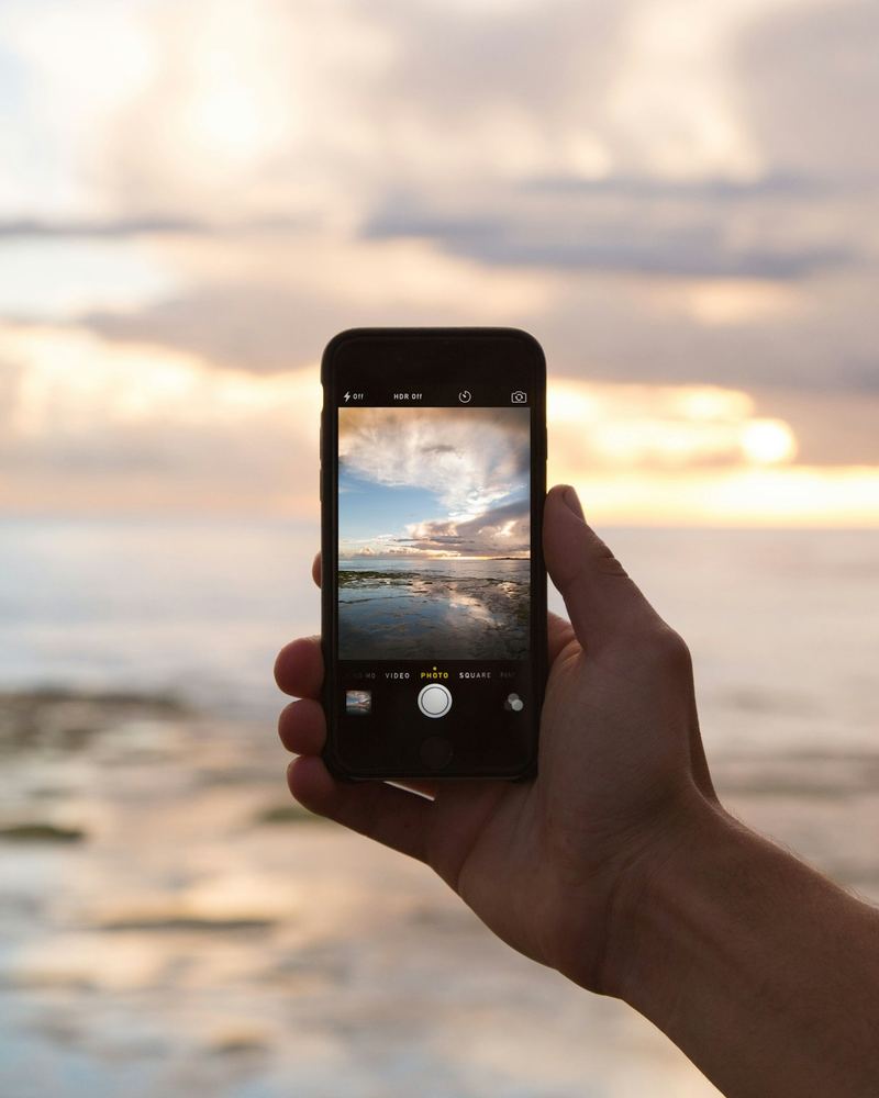 Traveller using mobile data on their phone at sunset abroad